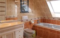 a bathroom with a toilet and a sink and a tub at Awesome Home In Plougonvelin With Private Swimming Pool, Can Be Inside Or Outside in Plougonvelin
