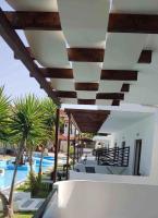 a white building with a swimming pool and a resort at Skiathos Holiday Resort in Skiathos