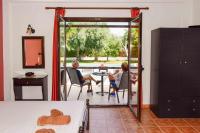 a man and a woman sitting at a table in a room at Skiathos Holiday Resort in Skiathos