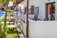 a balcony of a house with chairs and a pool at Skiathos Holiday Resort in Skiathos
