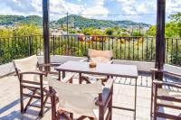 a patio with a table and chairs on a balcony at Skiathos Holiday Resort in Skiathos