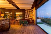 a restaurant with a table and chairs and a large window at Hotel Antonio in Zahara de los Atunes