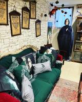 a green couch with pillows on it in a room at Les sorciers, la Diligence St Jean de Losne in Saint-Jean-de-Losne