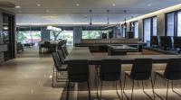 a restaurant with a bar with chairs and tables at CityInn Hotel Plus- Fuxing North Road Branch in Taipei