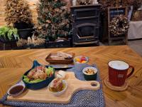 a table with a bowl of food and a plate of bread at Noosa海岸行館 in Fengbin