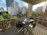a balcony with a table and chairs on a balcony at Magnifique logement avec terrasse &amp; climatisation in Aubervilliers