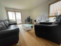 a living room with two couches and a table at Magnifique logement avec terrasse &amp; climatisation in Aubervilliers