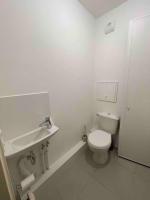 a white bathroom with a toilet and a sink at Magnifique logement avec terrasse &amp; climatisation in Aubervilliers
