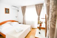 a hotel room with two beds and a window at COMPLEX TISMANA 3* ALL INCLUSIVE in Jupiter