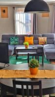 a living room with a couch and a table at Pannonia Apartman in Esztergom
