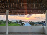 a view from the balcony of a resort with the sunset at Cappadocia Hotel in Nungwi