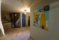 a hallway with paintings on the wall of a building at Charming Village Getaway in Bonnieux in Bonnieux