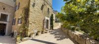 an alley in an old stone building with plants at Charming Village Getaway in Bonnieux in Bonnieux