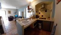 a kitchen with a sink and a living room at Charming Village Getaway in Bonnieux in Bonnieux