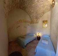 a bedroom with two beds and a stone ceiling at Charming Village Getaway in Bonnieux in Bonnieux