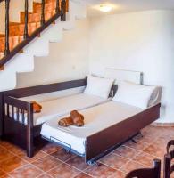 a bed in a room with a staircase at Skiathos Holiday Resort in Skiathos