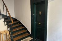 a staircase with a green door next to a stair case at Charming apartment in the heart of Paris in Paris