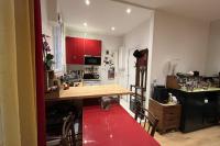 a kitchen with a wooden table and a red rug at Charming apartment in the heart of Paris in Paris