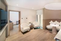 a hotel room with a bed and a desk and chairs at Sheraton Abu Dhabi Hotel & Resort in Abu Dhabi