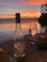 a bottle of wine sitting on a table with a glass at Ponci’s Gate to Gaia Holistic Center in Bocas del Toro