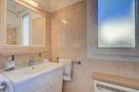 a bathroom with a sink and a mirror at Cap et Soleil - Happy Rentals in Antibes
