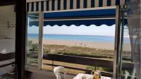 a view of the beach from a dining room window at Superbe vue pour ce joli T2 en front de mer -Wifi -Direct Plage-5PC254 in Saint-Cyprien-Plage