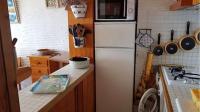 a kitchen with a white refrigerator and a stove at Superbe vue pour ce joli T2 en front de mer -Wifi -Direct Plage-5PC254 in Saint-Cyprien-Plage
