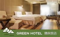 a green hotel room with a bed and a chair at Hotel Relax I in Taipei