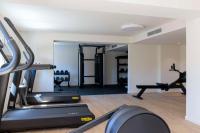 a gym with tread machines and a treadmill at Hilton Garden Inn Marseille Provence Airport in Marignane