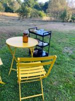 a yellow table and chairs sitting in the grass at Une pause en Corrèze in Sarroux