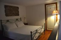 A bed or beds in a room at Palazzo Velli Suites