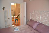 A bed or beds in a room at Palazzo Velli Suites