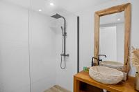 a bathroom with a sink and a mirror at Studio Sunshine in Le Diamant
