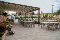 a patio with tables and chairs and umbrellas at Paleus Resort in Oradea