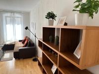 a living room with a book shelf and a couch at Heart of Klosterneuburg in Klosterneuburg