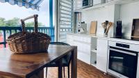a kitchen with a wooden table with a basket on it at Duplex à 50m de la plage du Diamant avec parking in Le Diamant