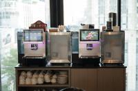 a restaurant with two krispy kreme machines at Hotel Clover Asoke - SHA Extra Plus in Bangkok
