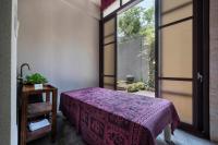 a bedroom with a purple bed and a window at Tai-Yi Red Maple Resort in Puli