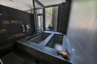 a bathroom with a large tub with a window at Tai-Yi Red Maple Resort in Puli