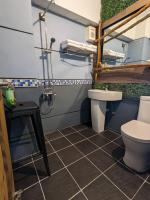 a bathroom with a toilet and a sink at Blackport Seaview Homestay in Yanliau
