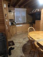 a kitchen with a wooden table and a table and chairs at Maison Sur 2 Niveaux in Nance