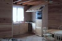 a kitchen with a stove and a sink and a window at Maison Sur 2 Niveaux in Nance