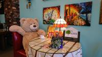 a teddy bear sitting in a chair next to a table at Bestime B&amp;B in Jiji