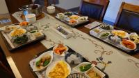 a table with several trays of food on it at Bestime B&amp;B in Jiji