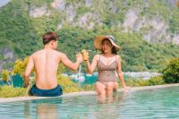 a man and a woman in the swimming pool at The Pyramid - Glamping at Karuna El Nido in El Nido