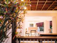 a dining room and kitchen with a table and chairs at Rendezvous Classic House in Chiang Mai