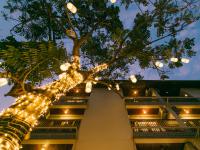 a christmas tree with lights in front of a building at Rendezvous Classic House in Chiang Mai
