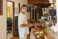 a man standing in a kitchen preparing food at Rendezvous Classic House in Chiang Mai