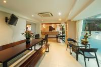 a dining room with a table and chairs at Rendezvous Classic House in Chiang Mai