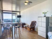 a living room with a table and chairs and a bedroom at Appartement chic vue mer in Le Barcarès